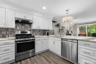 Open concept kitchen looking into living room and backyard