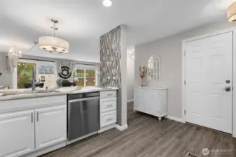 Open concept kitchen looking into living room and backyard
