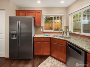 Gleaming stainless steel appliances complete this attractive heart of the home. Wave hello to your friends on the patio while you do the dishes. Wait a minute! Some friends...they should be helping you with the dishes...get in here!