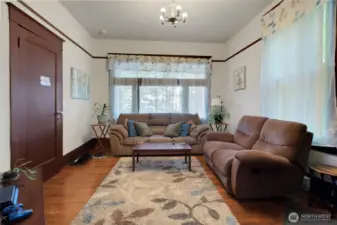 Unit A living room with large windows, it is at the front of the house.