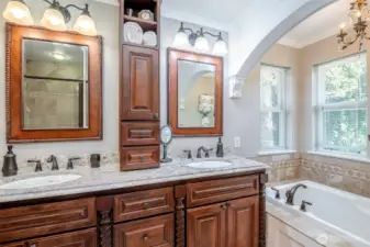 Updated primary5 piece bathroom suite with soaking tub, custom vanity, granite counters and tiled mud pan shower system
