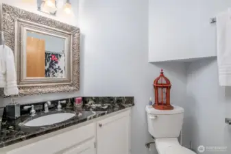 Secondary guest full bath with updated cabinets, countertops and tile floors.