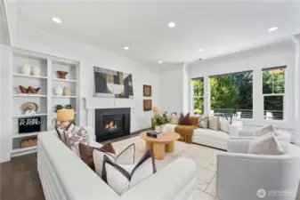 Spacious living area with a cozy fireplace and built in shelf.