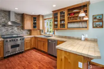 Huge six burner Viking stove, Bosch dishwasher, country style sink with multi-function faucet and glass cleaner.