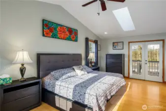 Primary bedroom with skylight, and sitting area.