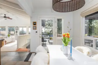 Find easy access for outdoor entertaining through the glass French door leading from the kitchen to both covered and uncovered outdoor view decks.