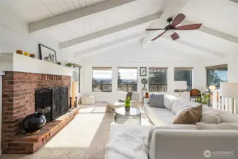Walls of windows welcome in natural light and frame breathtaking scenery.    Note the stair rail leading down to the lower level.