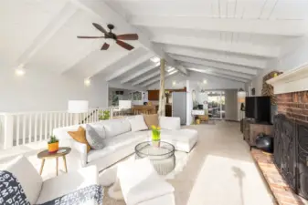 Gather around the cozy brick hearth for warmth and conversation or bask in natural light. This inviting space with a neutral palatte awaits your personal touch.