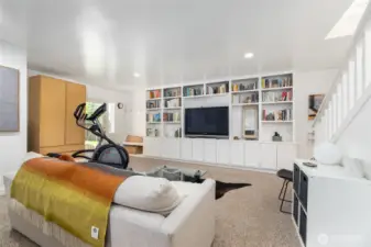 Display collections or collectibles in the built-in shelving or house your game day big screen in the lower living space.