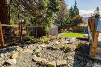 The extra large lot includes terraced pathways leading from the carport to the lower yard.