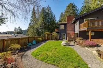 The fully fenced backyard is ready for gardening, your pet, and more with a nice lawn, large tool shed and hot tub too.