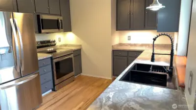 Stylish new countertops, refreshed cabinets, new sink, stainless appliances