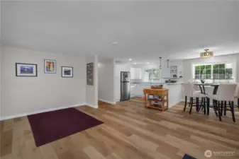 Living room, open concept flow to the kitchen and entry way