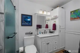 Fully remodeled bathroom with walk-in tiled shower.