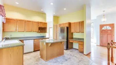 Ample counter space, built-in desk, tile floors and recessed lighting.