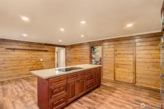 Kitchen island, walk in pantry to the right, the framed doorway in white leads to great room