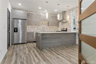 The kitchen is a standout featuring quartz countertops, gas cooking, a walk-in pantry and an oversized kitchen island.