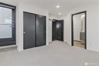 Primary bedroom located on 3rd floor with mini split for heating and cooling.  Easily fit a King bed in the 13'11" x 15'7" room.  Additional closet at top of stairs on third floor.  Door on left leads to rooftop deck.