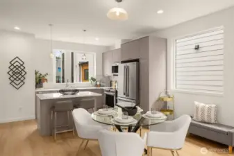 Gourmet kitchen featuring premium stainless steel appliances and a large eat-in island