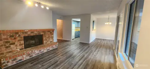 Living Room w/wood burning fireplace & new luxury plank flooring throughout.