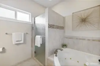 A huge jetted tub for two and a shower.
