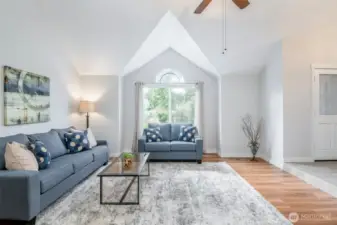 Spacious living room with ceiling fans for air movement