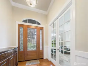 Grand entry into formal living room, dining, and den.