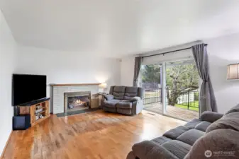 Large sliding doors in the living room lead out to the deck looking over the spacious, fenced back yard.