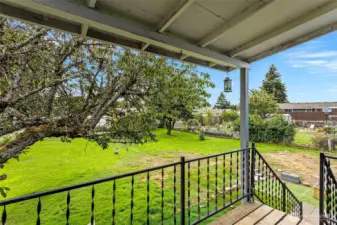 Main level deck off the living room leads down to back yard.