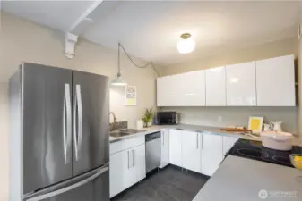 Large kitchen with a full sized refrigerator!  So much storage with two  Lazy Susan's and deep full extension drawers.