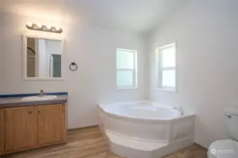 Bathroom boasts a large tub to soak all your troubles away.