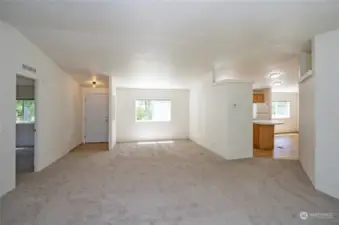 Oversized living room off the entry. Split bedroom floor plan. Door on the left leads to the primary suite.