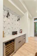 Dining area buffet with Dacor wine refrigerator,and a beautiful , mosaic tile backsplash.