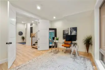 Office/den with oversized French doors opens up to the great room.