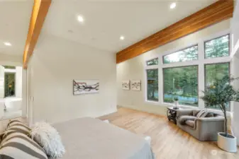 Primary bedroom suite with exposed beams & a Cascade foothill view.