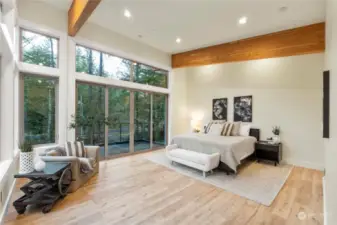 Upper Floor Primary Bedroom with floor to ceiling windows.