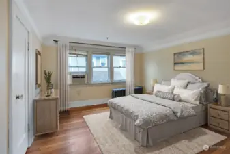 Upper-level bedrooms boast of hardwood floors. This photo has been virtually staged.