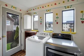 A cheery laundry/mudroom with access door to back yard.