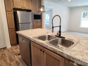 Another view of the nice fixtures in the kitchen and view to the livingroom area.