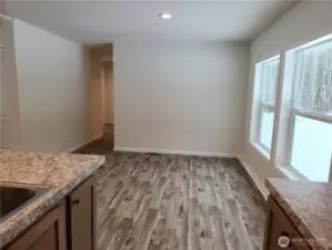 Lots of space for a good sized diningroom table and more large windows to view the beautiful space outside. Hallway leads to 2 bedrooms and a den or make it another bedroom!