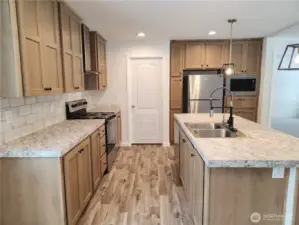 All stainless steel appliances included, with tile backsplash and light colored cabinetry really make the kitchen pop!