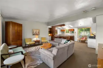 Generously sized living space leads to bonus room and deck while overlooking the water.