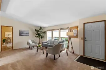 Living room off entrance looking into primary bedroom.