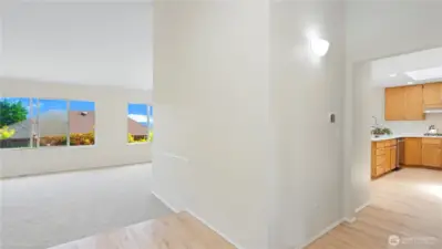 Hardwood floors in the entry, hallway, kitchen, pantry, and the dining room.  Kitchen is to the right and bedrooms to the left.