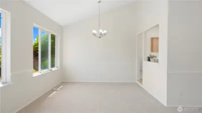 See that the living room flows into the dining room and kitchen areas.  High ceiling makes the sunshine fill this room.