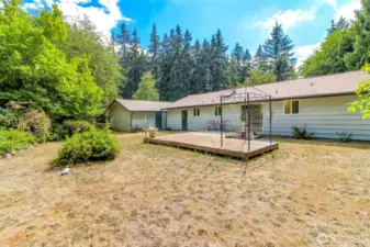 This view of the back of the home also shows the shed connected to the back of the detached garage.