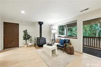 Sliding doors lead out onto a long deck, and out into the back yard.