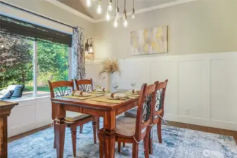 The dining room surrounds you in elegance with serene views to the rear yard and deck.