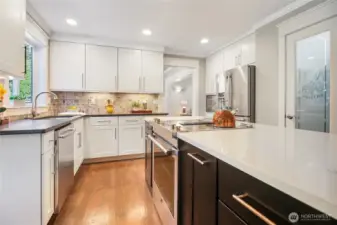 The kitchen is the heart of the home with custom cabinets that go all the way to the ceiling. Soft-close drawers, pull out shelving in the lower cabinets, and specialty cabinets make cooking in this kitchen a delight. Top-of-the-line stainless steel appliances and a walk-in pantry add to the enjoyment. Quartz counters make clean up a breeze. Under-cabinet lighting and upgraded molding creates a luxurious feeling.