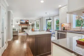 A view from the kitchen towards the nook and family room spaces. A French door leads to the rear deck and yard.